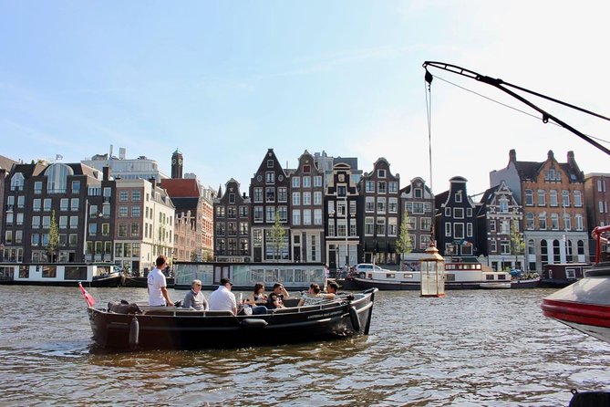 Amsterdam Canal Tour by Open Boat – 90 min Small Group Experience - De Wallen, old churches, and the Kolksluis