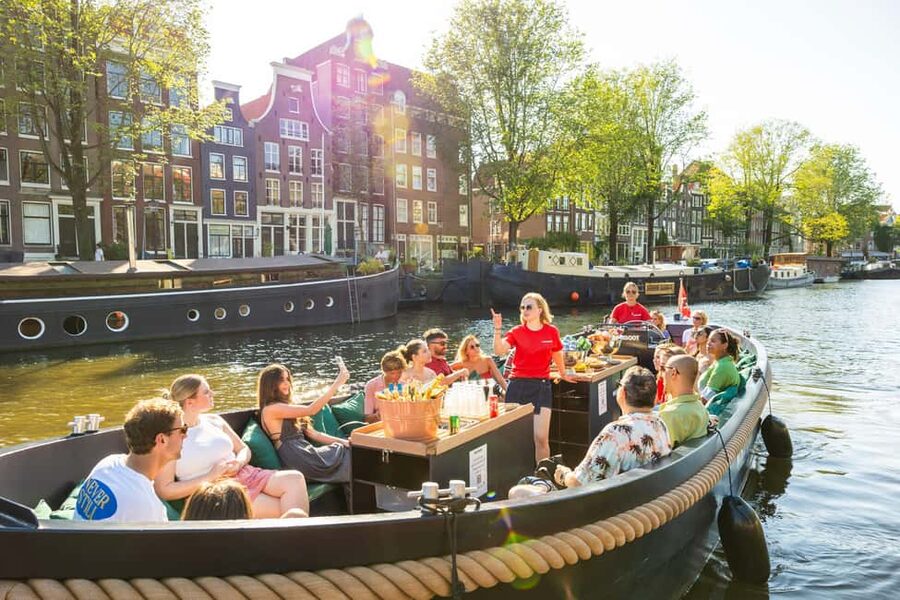 Amsterdam: Guided Open Boat Canal Cruise Including Drink - Setting out opposite Amsterdam Centraal Station