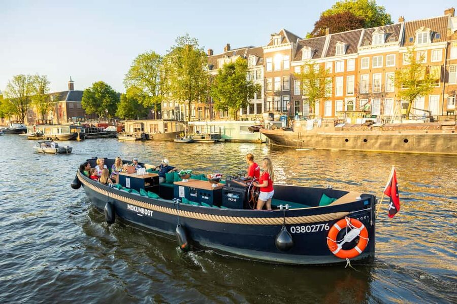 Amsterdam: Guided Open Boat Canal Cruise Including Drink - Returning through the harbor