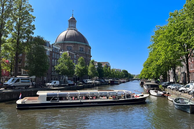A canal cruise boat under the bridges of the Amsterdam ring
